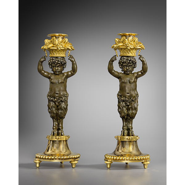 A pair of putto candlesticks attributed to Rémond