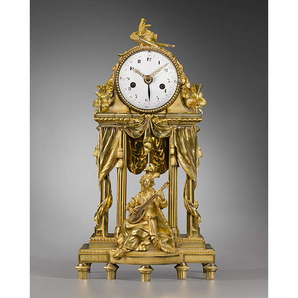 A Louis XVI two-coloured gilt bronze mantel clock representing Theatre and Music