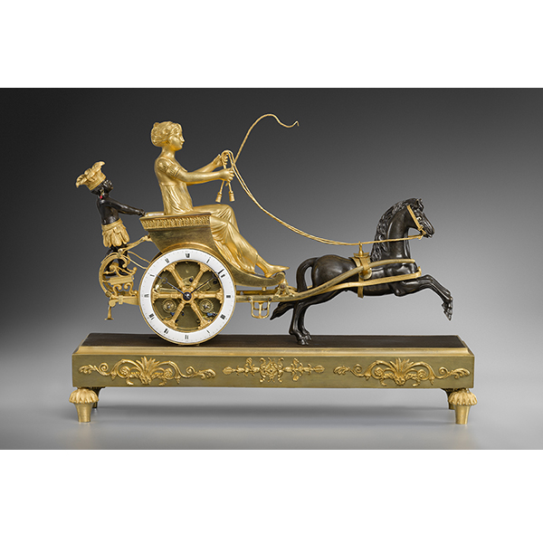 Une pendule en bronze ciselé, doré et patiné, représentant une jeune femme de la Louisiane assise dans un char rentrant des plantations