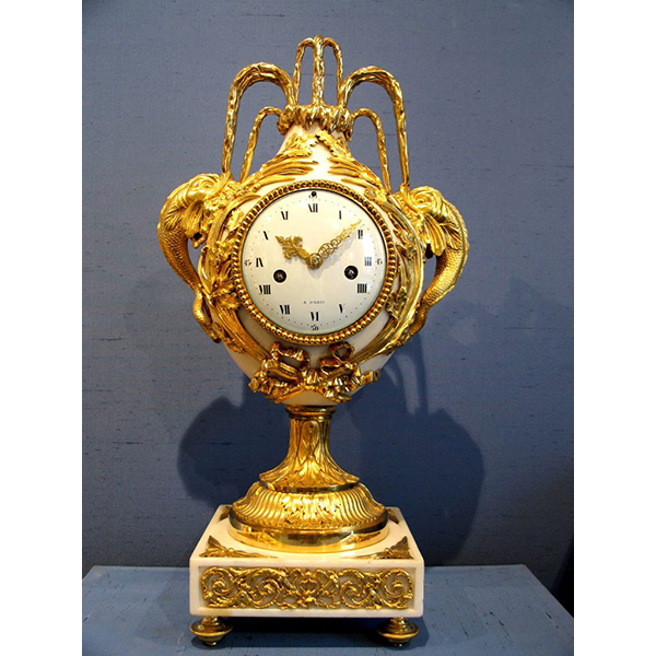 A Louis XVI white marble vase clock with aquatic motifs